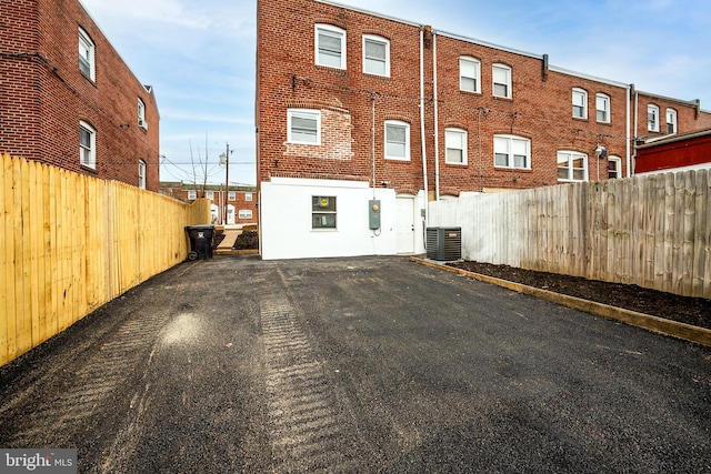 rear view of property featuring a fenced backyard and cooling unit