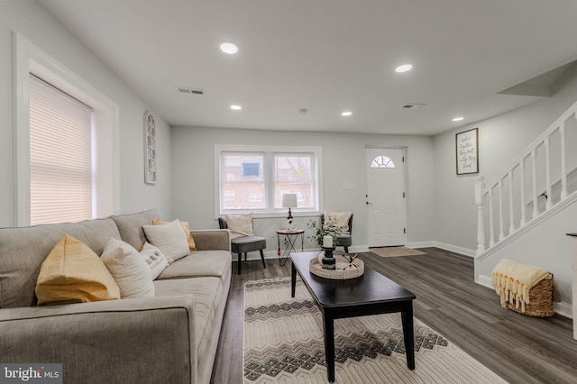 living room with dark wood-style floors, baseboards, stairway, and recessed lighting