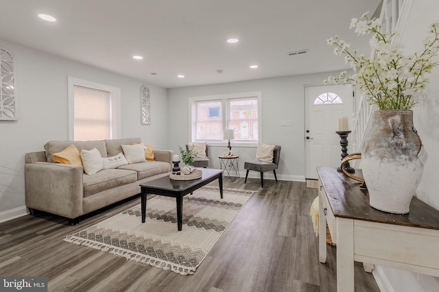 living room featuring baseboards, dark wood-type flooring, visible vents, and recessed lighting