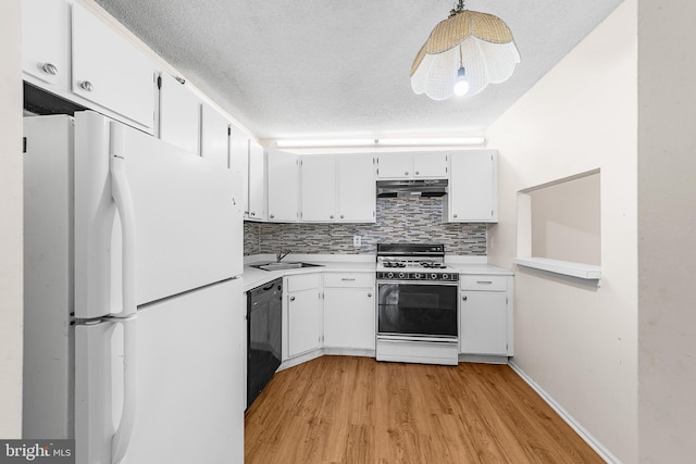 kitchen featuring backsplash, under cabinet range hood, light countertops, white appliances, and a sink