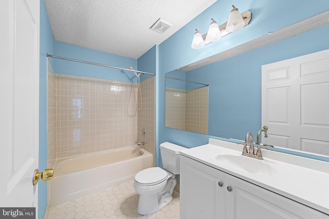 bathroom with vanity, visible vents, a textured ceiling, tile patterned floors, and toilet