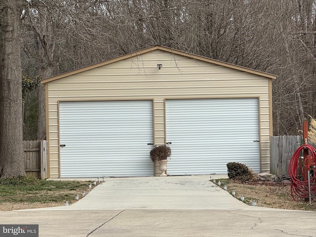 detached garage featuring fence