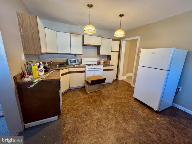 kitchen featuring white appliances, a toaster, decorative light fixtures, white cabinetry, and a sink