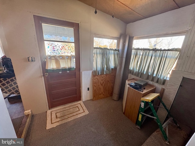 entryway with carpet flooring and vaulted ceiling