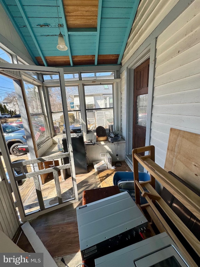 sunroom / solarium featuring lofted ceiling