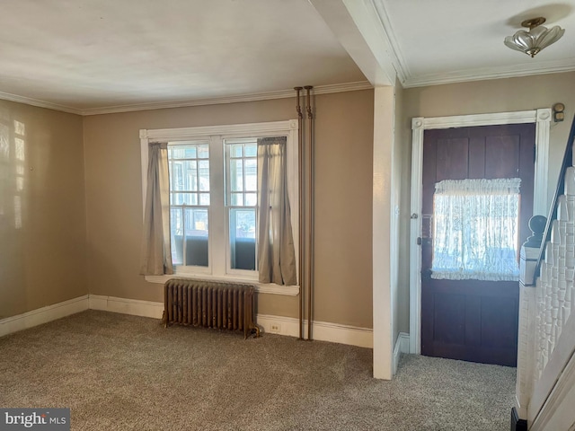 carpeted entrance foyer featuring ornamental molding, radiator heating unit, and baseboards