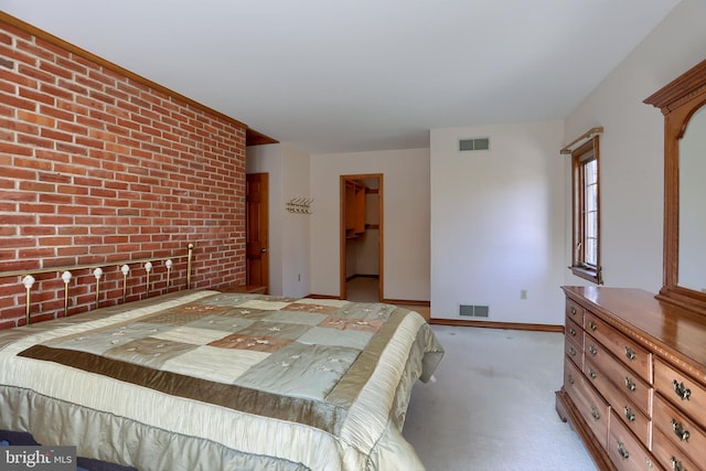 bedroom featuring brick wall, a closet, carpet flooring, and visible vents