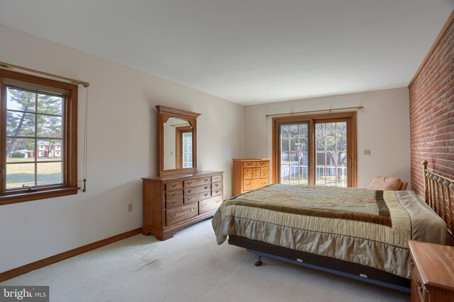 bedroom featuring access to exterior, baseboards, and carpet flooring