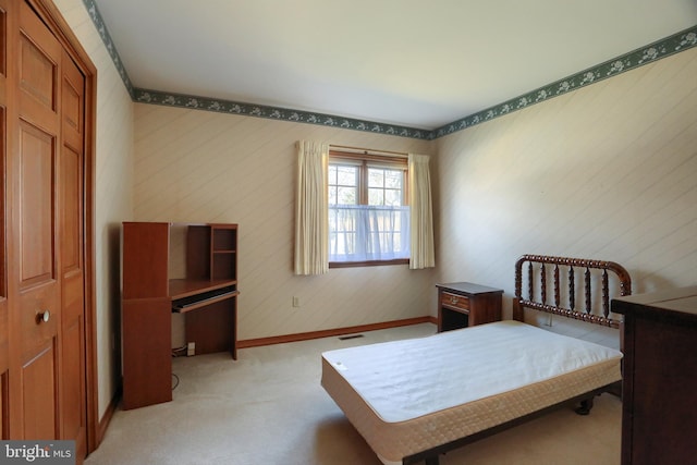 bedroom featuring light carpet, visible vents, and baseboards