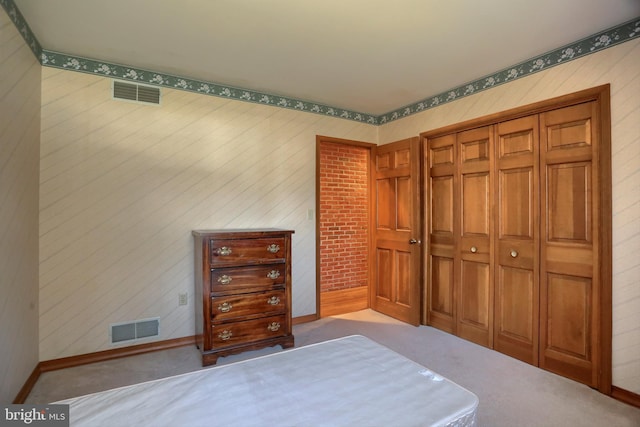 bedroom featuring carpet, a closet, visible vents, and baseboards