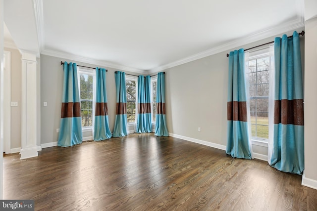 unfurnished room with plenty of natural light, ornate columns, and wood finished floors