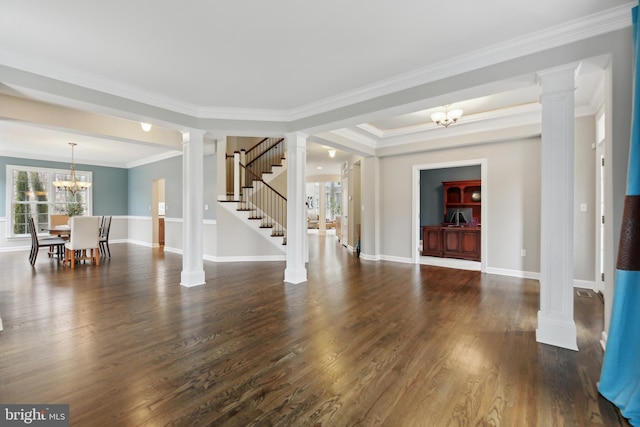 unfurnished living room featuring stairway, decorative columns, a chandelier, and dark wood-style flooring