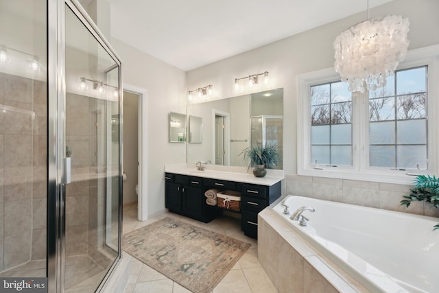 full bath featuring toilet, tile patterned flooring, vanity, a shower stall, and a bath