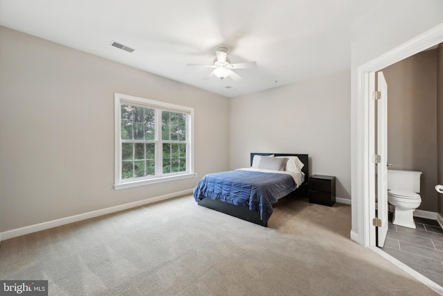 bedroom with visible vents, carpet flooring, ceiling fan, ensuite bath, and baseboards