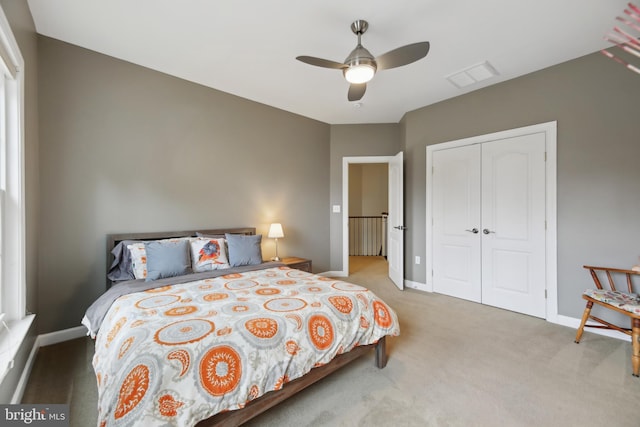 bedroom with a closet, carpet flooring, and baseboards