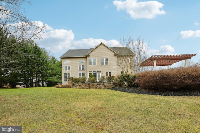 rear view of house with a lawn and a pergola