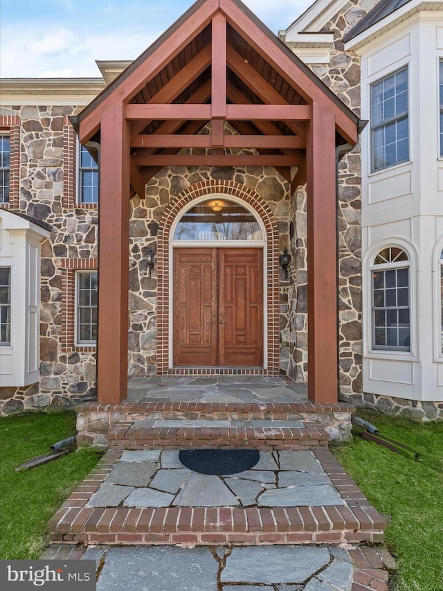 entrance to property featuring stone siding