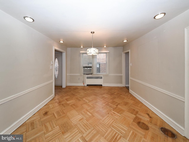 unfurnished dining area featuring radiator heating unit and baseboards