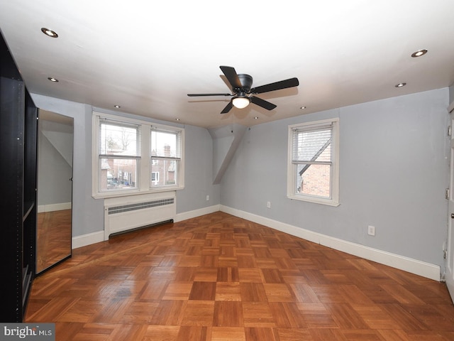 bonus room with radiator, baseboards, and recessed lighting