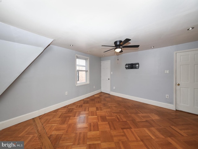 additional living space featuring ceiling fan and baseboards