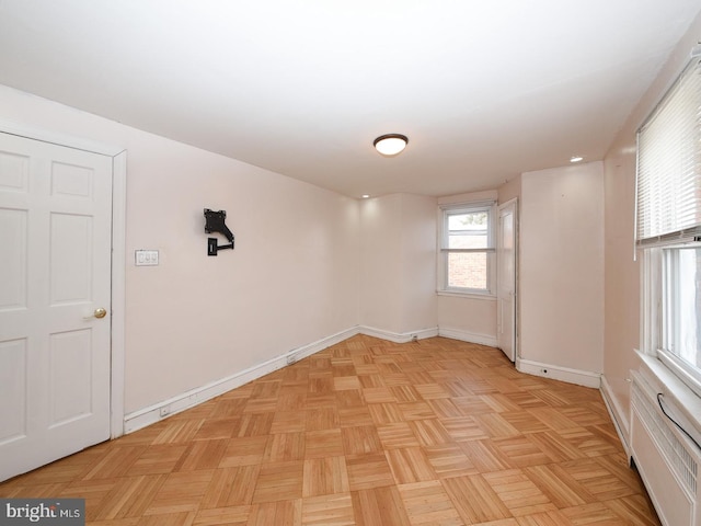 unfurnished room with baseboards