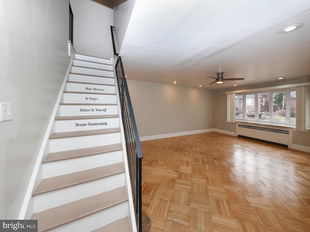 staircase with recessed lighting, baseboards, ceiling fan, and baseboard heating