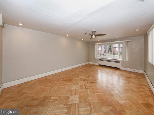 empty room with a baseboard radiator, baseboards, a ceiling fan, and recessed lighting