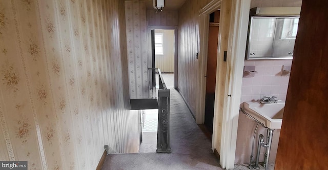 hallway with carpet flooring and wallpapered walls