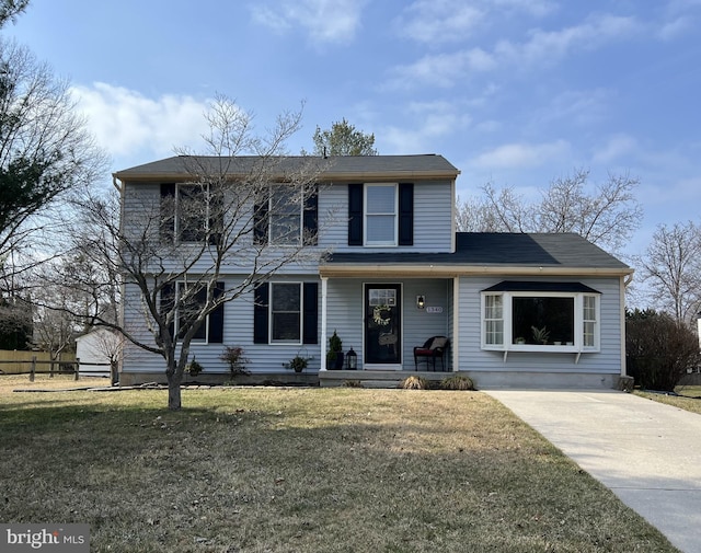 traditional-style house with a front yard and covered porch