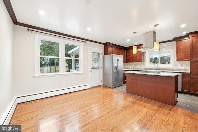 kitchen featuring stainless steel fridge, island range hood, light wood-style flooring, ornamental molding, and backsplash