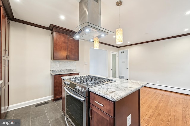 kitchen featuring tasteful backsplash, a baseboard radiator, visible vents, stainless steel gas stove, and island range hood