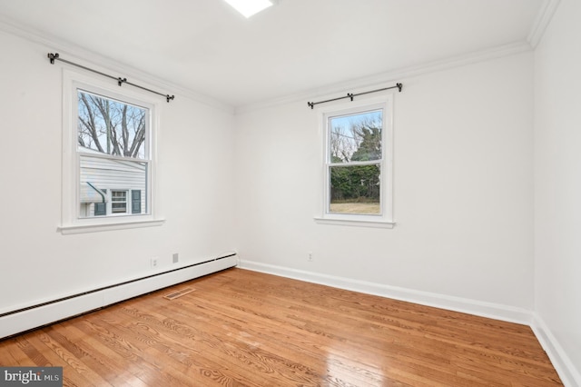 unfurnished room with light wood finished floors, baseboards, ornamental molding, and baseboard heating