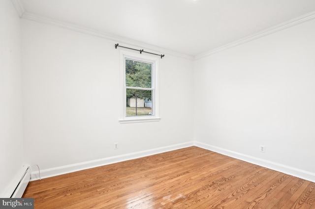 empty room with light wood finished floors, a baseboard heating unit, and ornamental molding