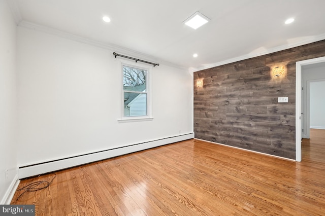 unfurnished room with recessed lighting, wood walls, wood finished floors, ornamental molding, and baseboard heating