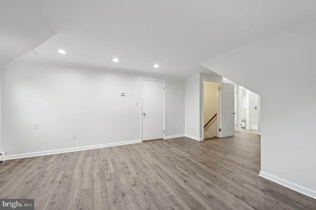 interior space featuring baseboards, wood finished floors, and recessed lighting