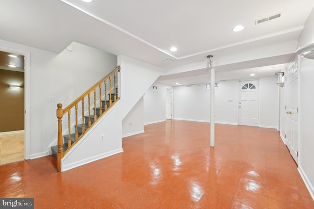 finished below grade area featuring recessed lighting, visible vents, baseboards, and stairs