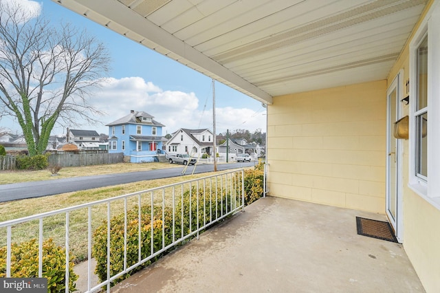 balcony with covered porch and a residential view