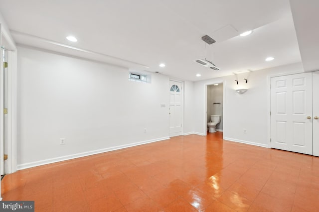 basement with baseboards and recessed lighting