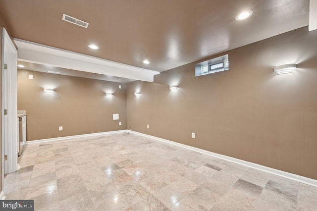 finished below grade area with baseboards, visible vents, and recessed lighting