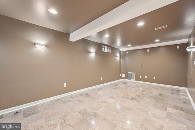 finished basement featuring recessed lighting, visible vents, and baseboards