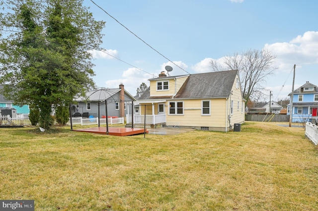 back of house with a yard, a chimney, fence, cooling unit, and a wooden deck