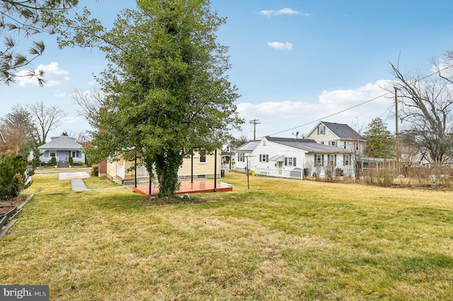 view of yard featuring a deck and fence