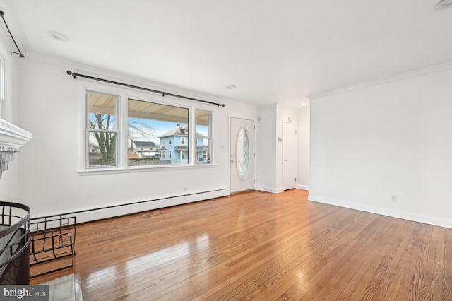 living room featuring baseboards, a baseboard radiator, ornamental molding, and hardwood / wood-style floors