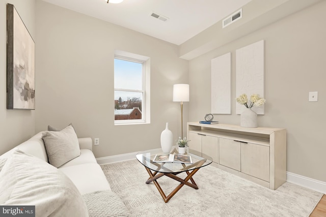 living area featuring visible vents and baseboards