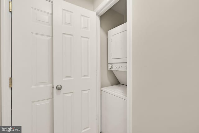 laundry room with stacked washing maching and dryer and laundry area