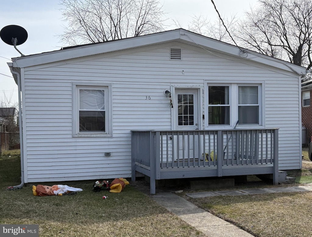 back of house with a deck