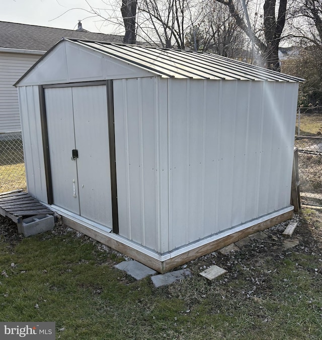 view of shed featuring fence
