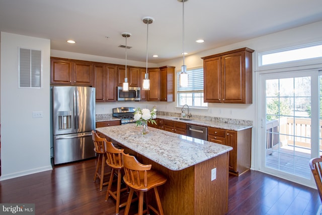 kitchen featuring dark wood-style floors, visible vents, stainless steel appliances, and a sink