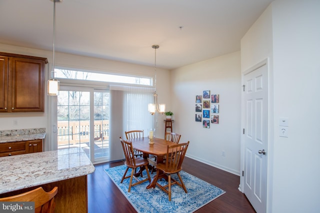 dining area with dark wood-style floors and baseboards