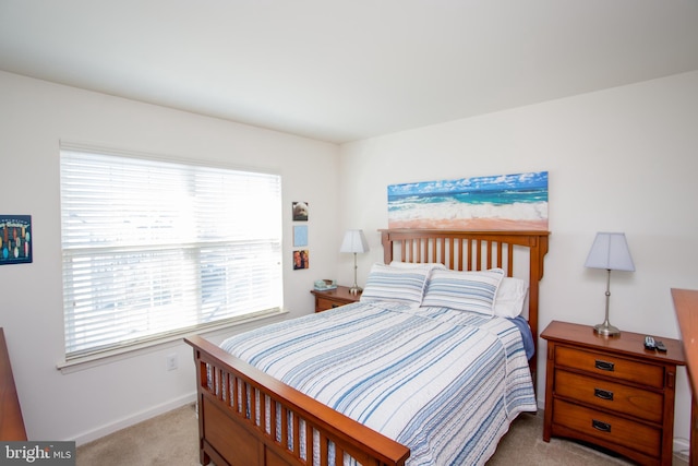 bedroom with multiple windows, carpet flooring, and baseboards